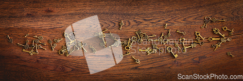 Image of Magical bronze keys on a wooden oak surface