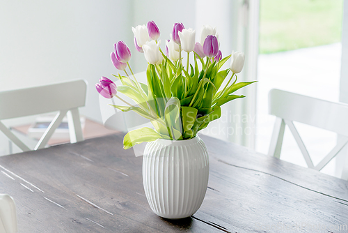 Image of Bouquet of tulip flowers in a white vase