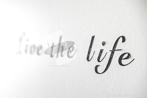 Image of Live the life word phrase on a white wall