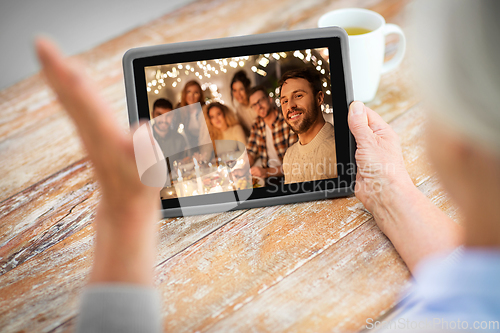 Image of old woman has video call with family on christmas