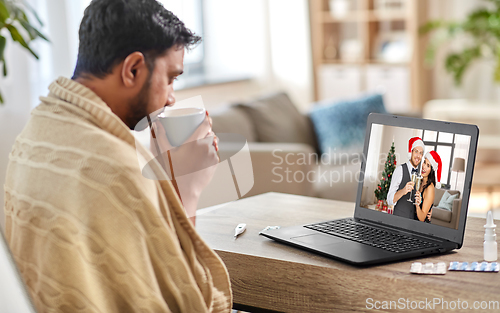 Image of sick man having video call with friends at home