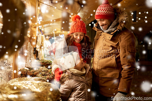 Image of happy family at christmas market in city