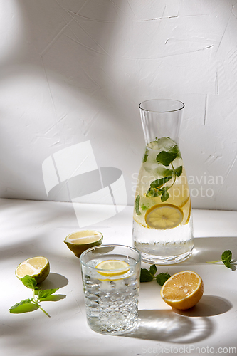 Image of glasses with lemon water and peppermint on table