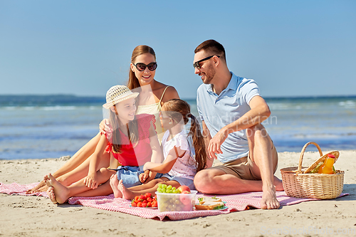 Image of happy family having picnic on summer beach