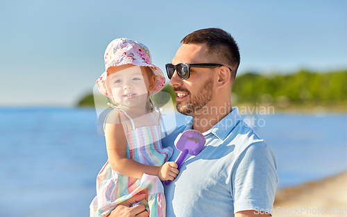 Image of happy father with little daughter on beach