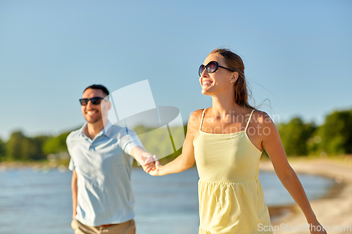 Image of happy couple hugging on summer beach