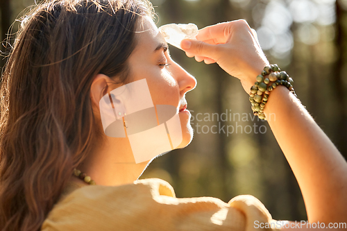 Image of woman or witch performing magic ritual in forest