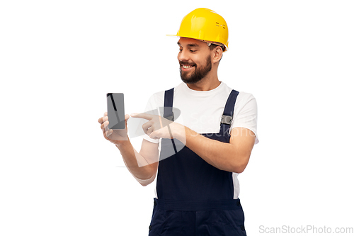 Image of happy male worker or builder showing smartphone