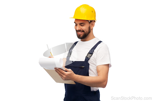 Image of male worker or builder in helmet with clipboard