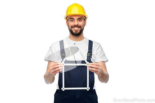 Image of happy male worker or builder with carpenter's rule