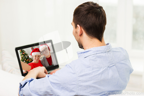 Image of man having video call with family on christmas