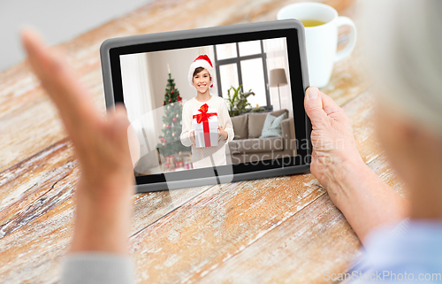 Image of grandmother has video call with boy on christmas