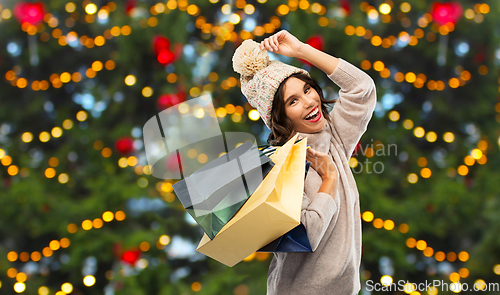 Image of young woman in winter hat with shopping bags