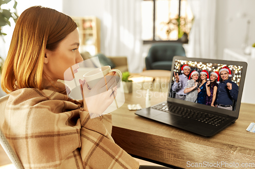 Image of sick woman having video call with friends at home