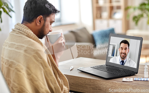Image of sick man having video call with doctor at home