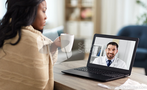 Image of sick woman having video call with doctor on laptop