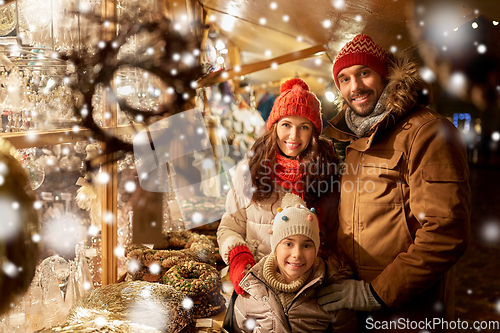 Image of happy family at christmas market in city