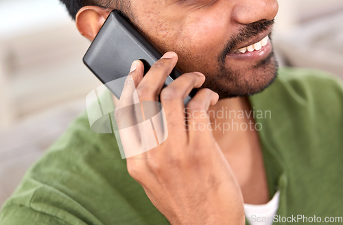 Image of close up of happy indian man calling on smartphone