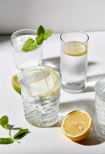 Image of glasses with lemon water and peppermint on table