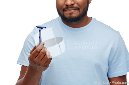 Image of close up of african american man with razor blade