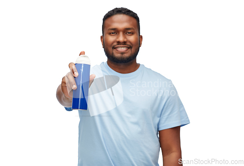 Image of happy african man showing shaving foam to camera