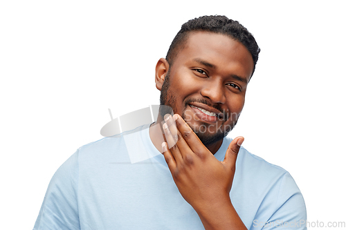 Image of happy african american man touching his beard