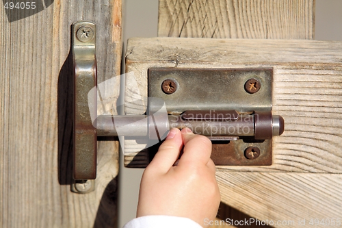 Image of Baby opening a door