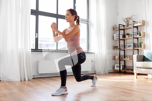 Image of young woman exercising at home