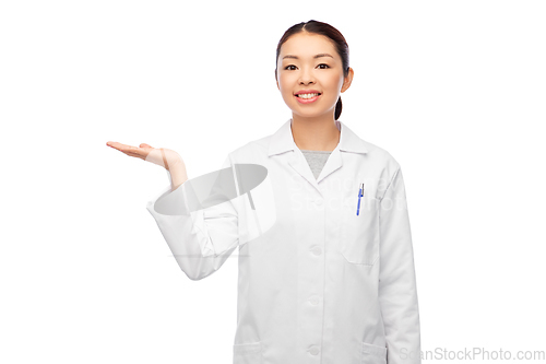 Image of asian female doctor holding something on hand