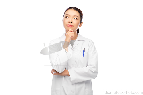 Image of thinking asian female doctor in white coat