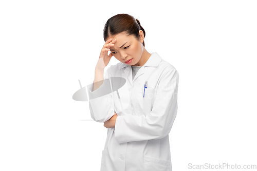 Image of sad thinking asian female doctor in white coat