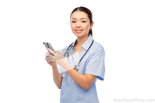 Image of happy asian female doctor or nurse with smartphone