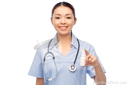 Image of smiling asian female doctor or nurse with medicine