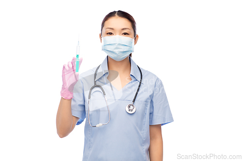 Image of asian nurse in mask with medicine in syringe