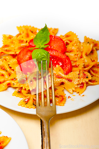 Image of Italian pasta farfalle butterfly bow-tie and tomato sauce