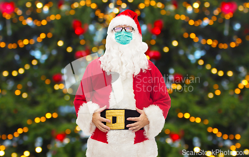 Image of man in costume of santa claus wearing medical mask