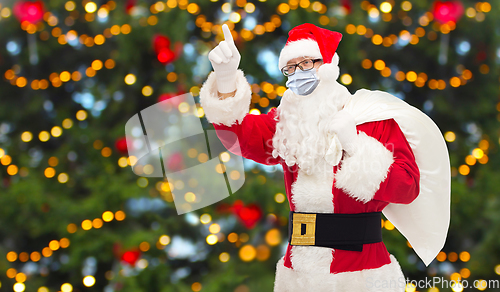 Image of man in costume of santa claus wearing medical mask