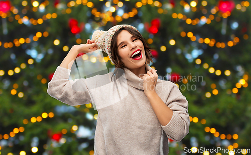 Image of happy woman in hat and sweater on christmas