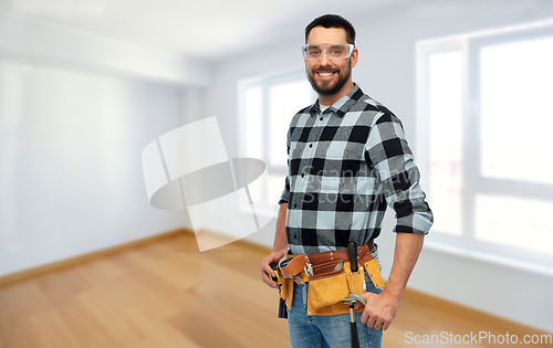 Image of happy male worker or builder with tool belt