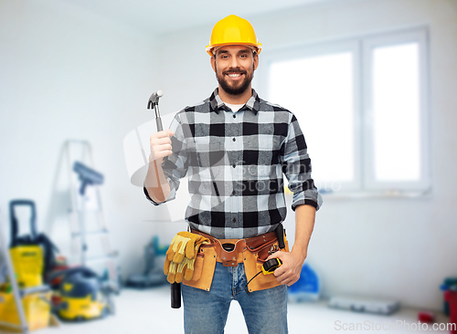 Image of happy male builder in helmet with hammer