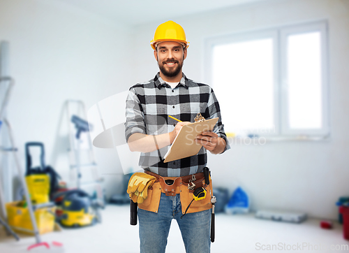 Image of male worker or builder in helmet with clipboard