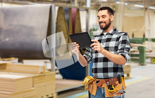 Image of happy builder with tablet computer and tools