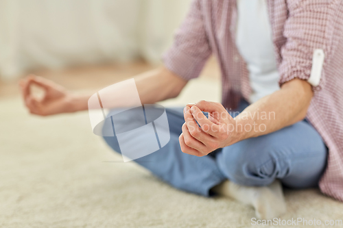 Image of close up of man meditating at home