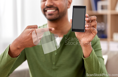 Image of close up of smiling man showing smartphone at home