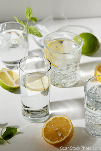 Image of glasses with lemon water and peppermint on table