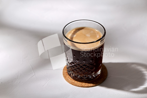 Image of glass of coffee on cork drink coaster