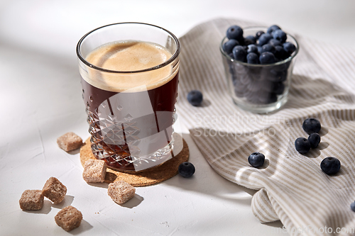 Image of glass of coffee, brown sugar and blueberries