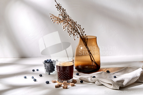 Image of glass of coffee, brown sugar and blueberries