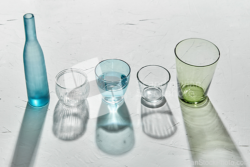 Image of glassware dropping shadows on white surface