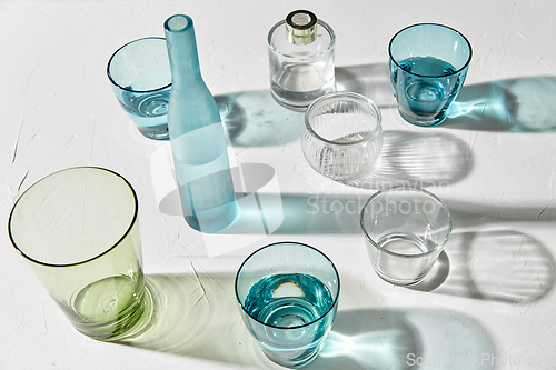 Image of glassware dropping shadows on white surface